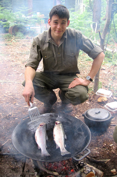 A keen fisherman, Dan prepares his catch for the team's supper