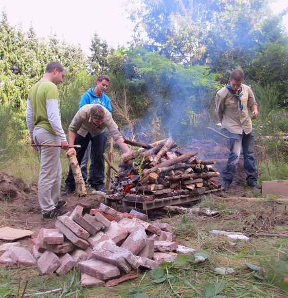 A fire is built and lit on top of the hangi to heat the bricks underneath