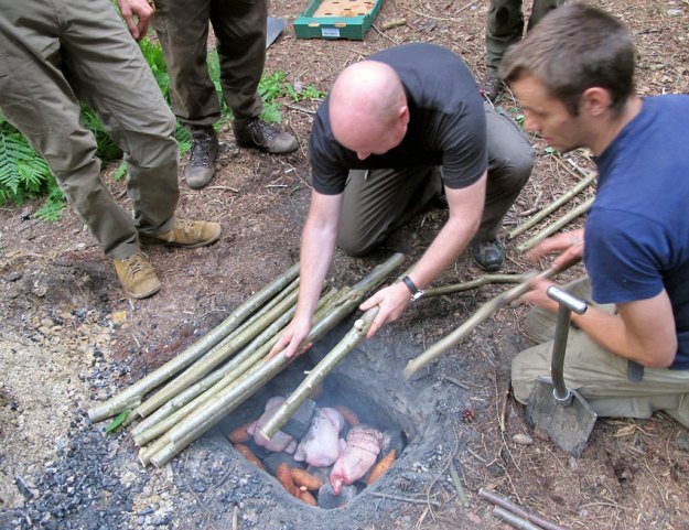 Students utilise the ground oven method of cooking, on Woodlore's Traditional Living Skills course