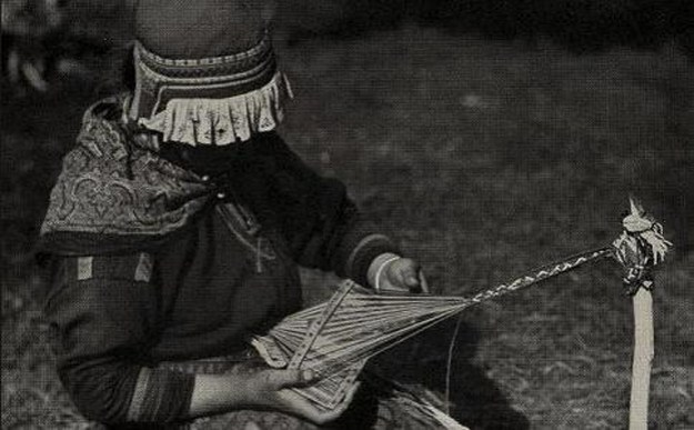 Sami woman weaving a band on a rigid heddle loom